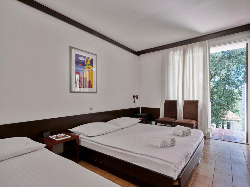 Postel nebo postele na pokoji v ubytování Koversada Rooms