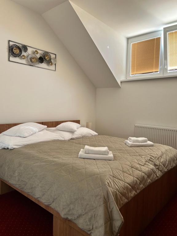 Postel nebo postele na pokoji v ubytování Hotel Evan u Hoffera