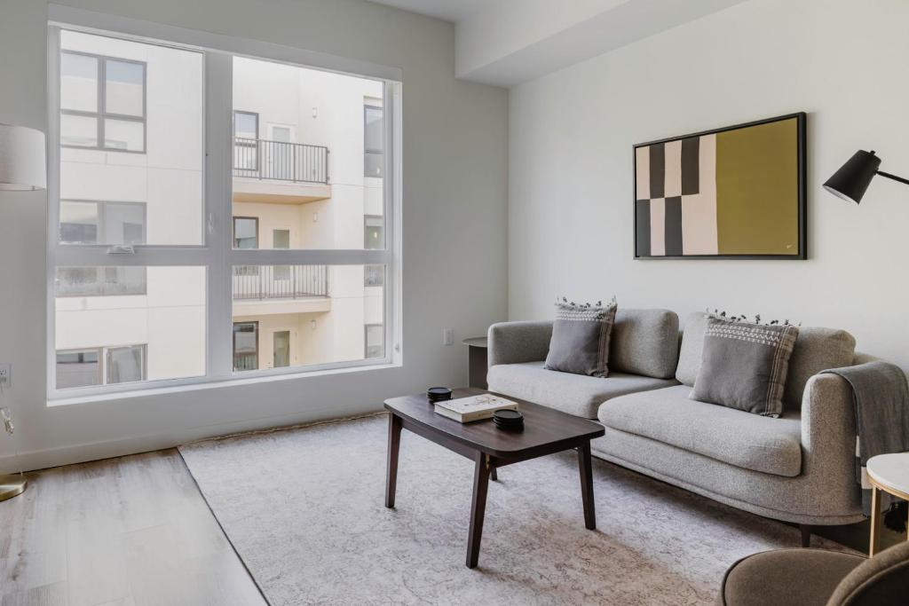 a living room with a couch and a table at Blueground Hayward on-site retail restaurants SFO-1703 in Hayward