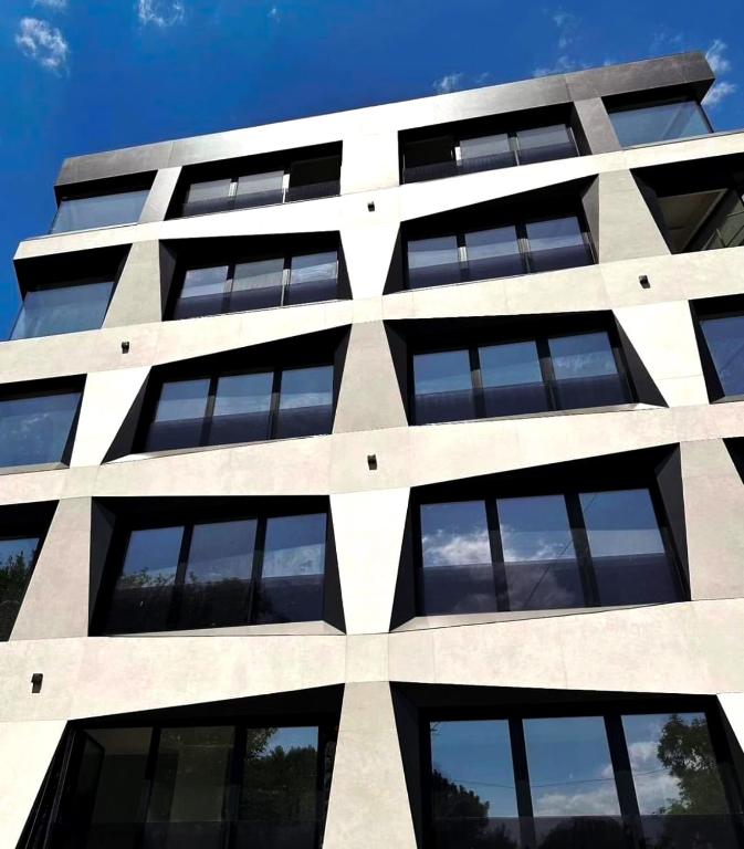 a tall white building with lots of windows at Luxury living by Dazzie in Skopje