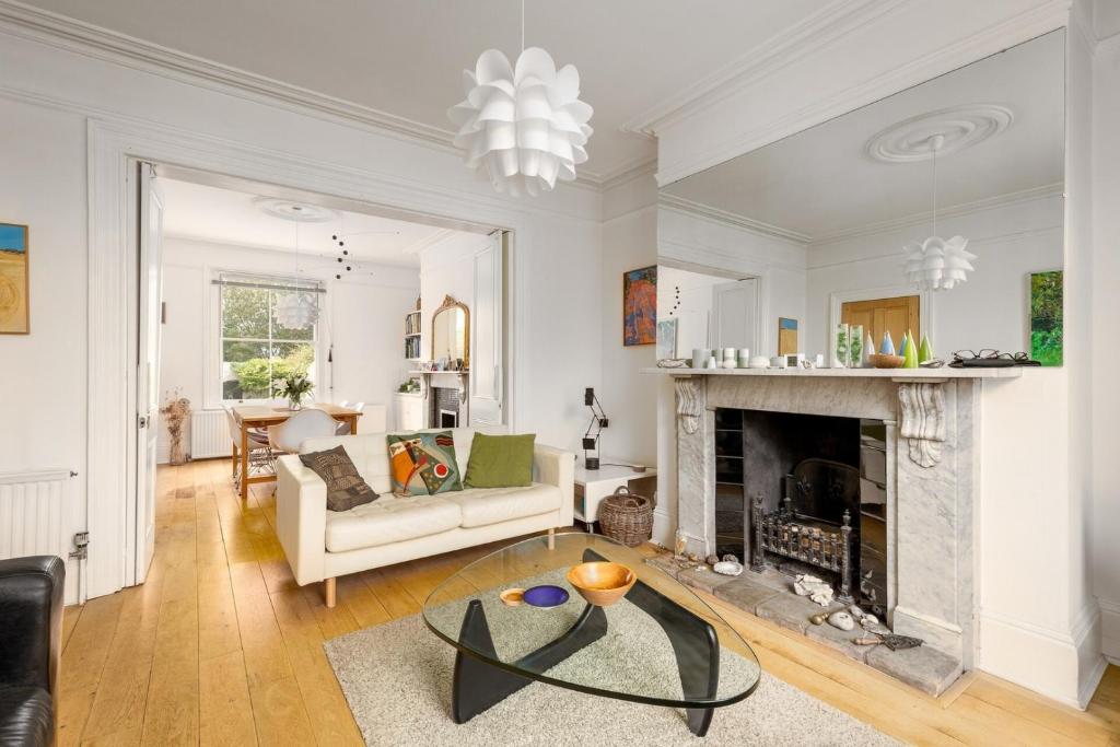a living room with a couch and a fireplace at 3BD Victorian Townhouse Near Norfolk Broads 4A, 2C in Beccles