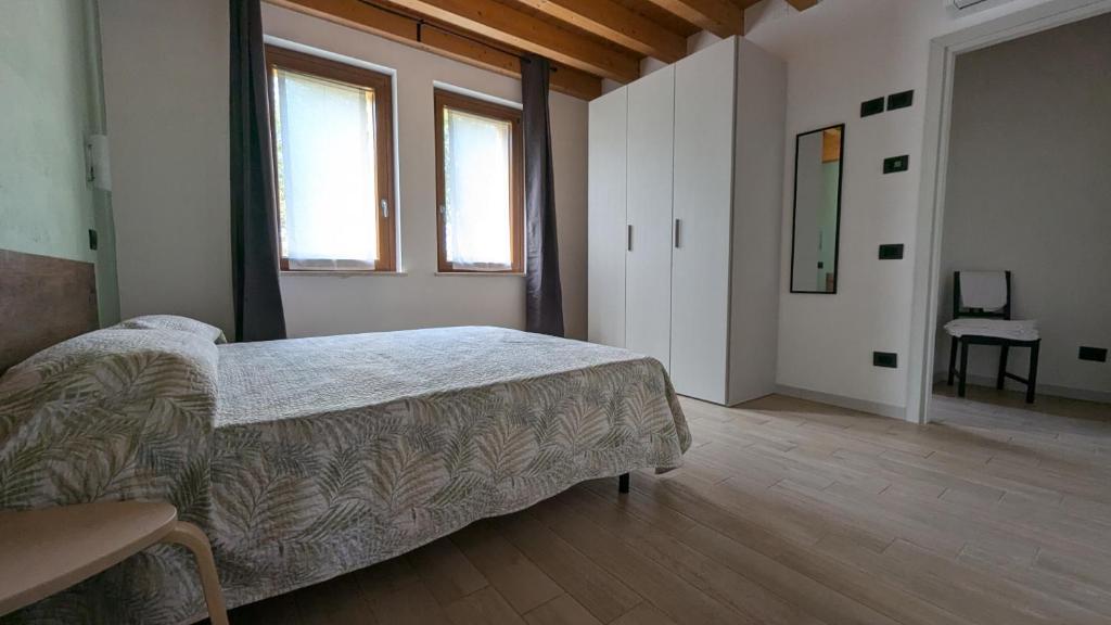 Postel nebo postele na pokoji v ubytování Agriturismo Ai Tre Fienili