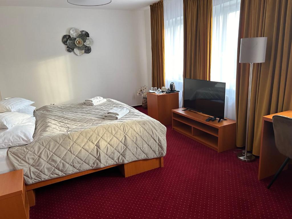 Postel nebo postele na pokoji v ubytování Hotel Evan u Hoffera