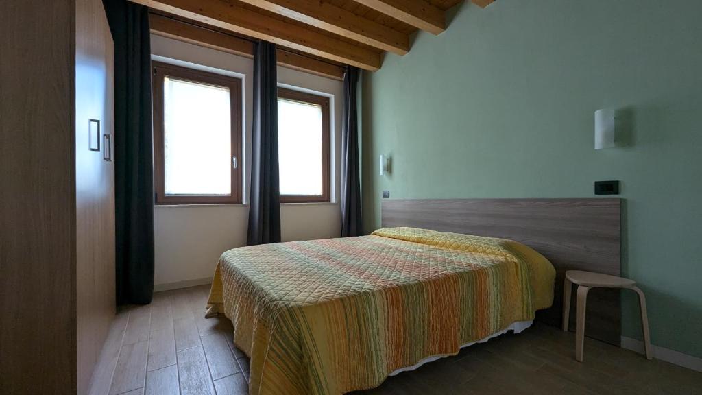 Postel nebo postele na pokoji v ubytování Agriturismo Ai Tre Fienili