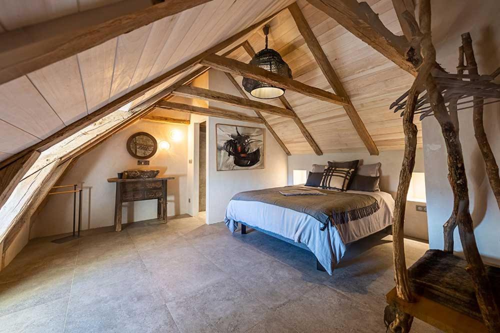 a bedroom with a bed in an attic at Les Terrasses de Majorac in Bozouls