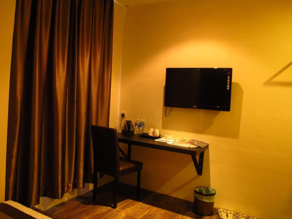 TV a/nebo společenská místnost v ubytování Hotel Austin Paradise