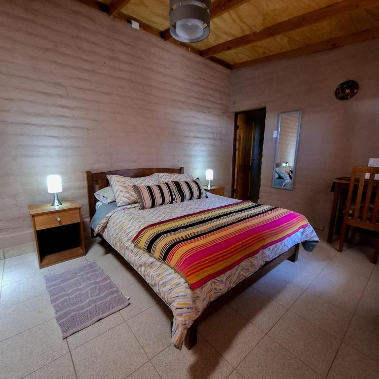 Postel nebo postele na pokoji v ubytování Hostal Hara