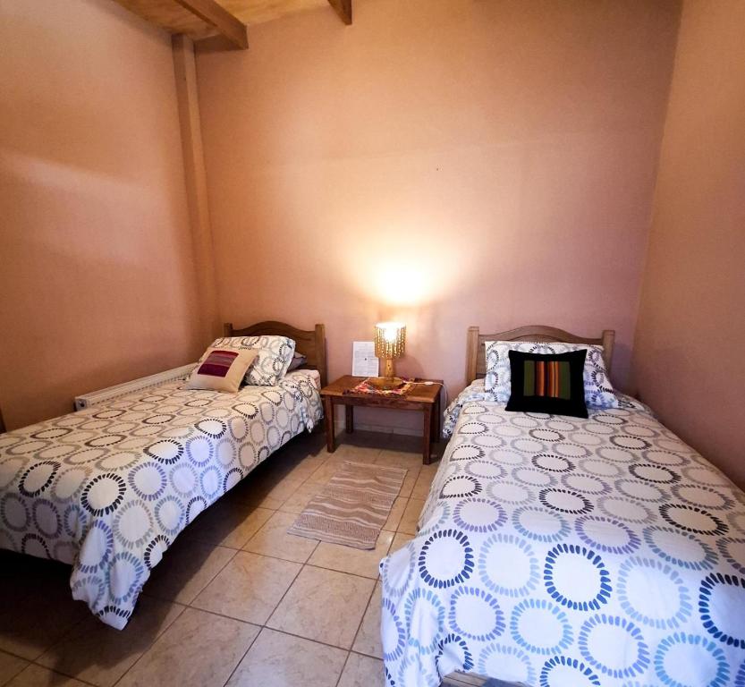Postel nebo postele na pokoji v ubytování Hostal Hara