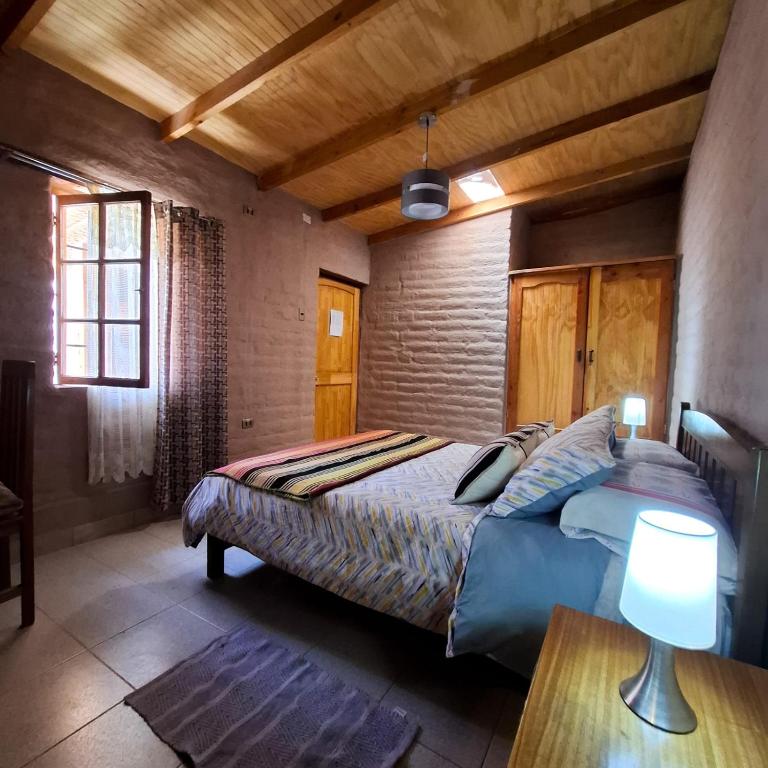 Postel nebo postele na pokoji v ubytování Hostal Hara
