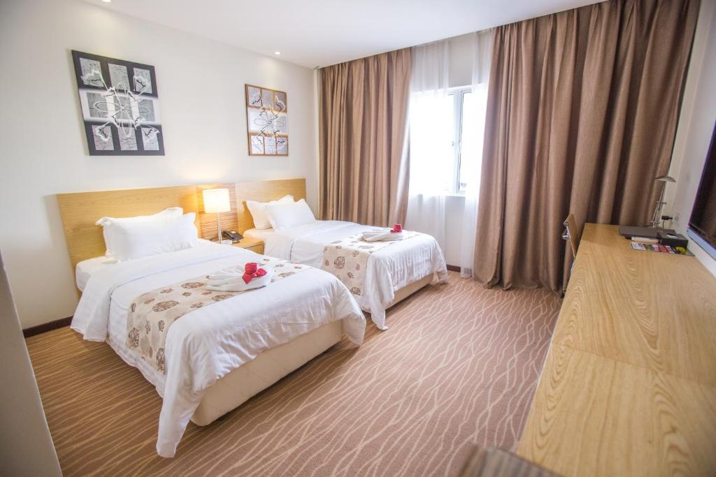 Postel nebo postele na pokoji v ubytování VIP Hotel Segamat