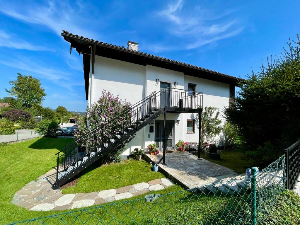 a house with a staircase in front of it at Ferienhaus Hanni und Fanni in Taching am See