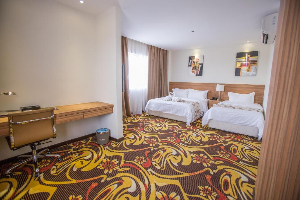 Postel nebo postele na pokoji v ubytování VIP Hotel Segamat