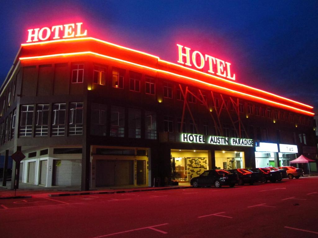a hotel with neon signs on the front of it at Hotel Austin Paradise in Johor Bahru