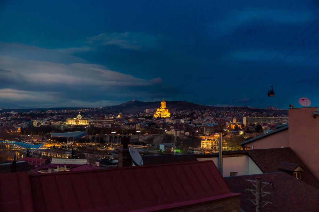 a view of a city at night at Apartamenti Gomi 17 in Tbilisi City