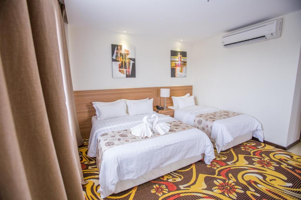 Postel nebo postele na pokoji v ubytování VIP Hotel Segamat