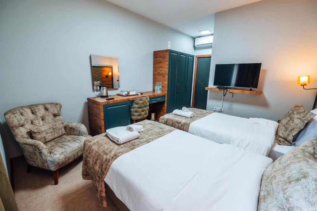 Postel nebo postele na pokoji v ubytování Mysia Olympos Hotel