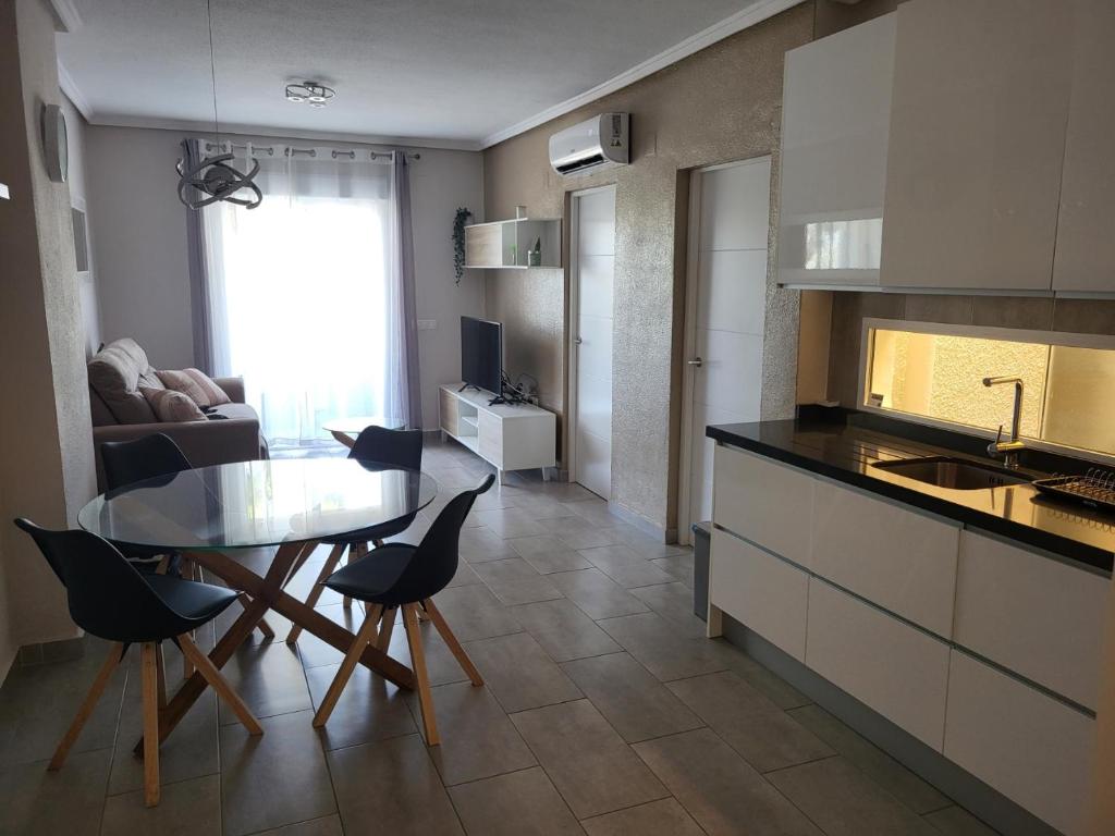 a kitchen and living room with a table and chairs at Appartement Bella Vista in Rojales