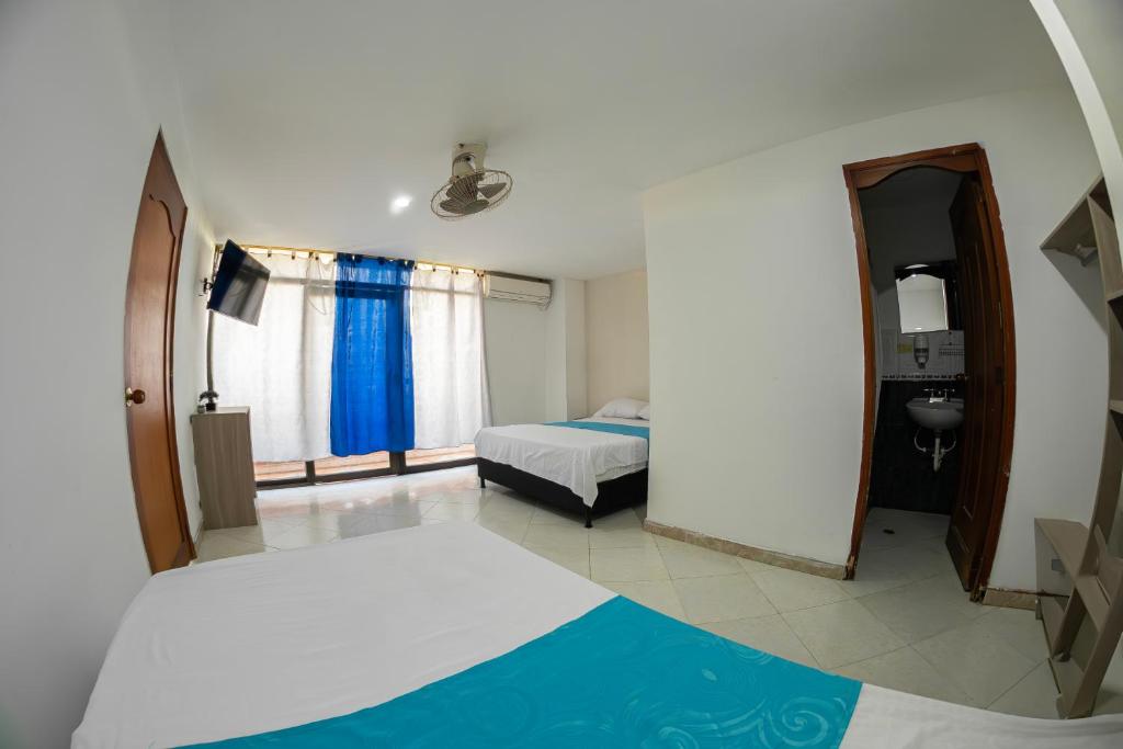 Postel nebo postele na pokoji v ubytování Hotel Santander Plaza