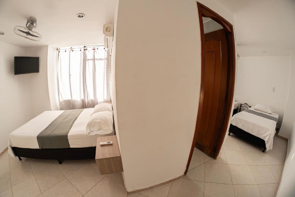 Postel nebo postele na pokoji v ubytování Hotel Santander Plaza