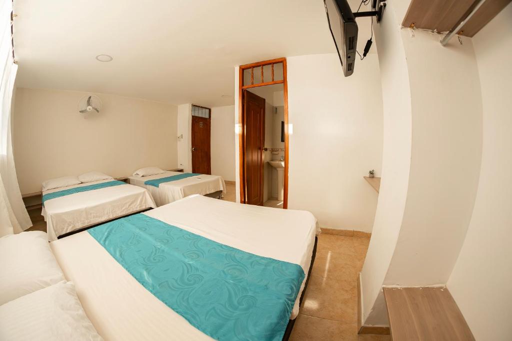 Postel nebo postele na pokoji v ubytování Hotel Santander Plaza