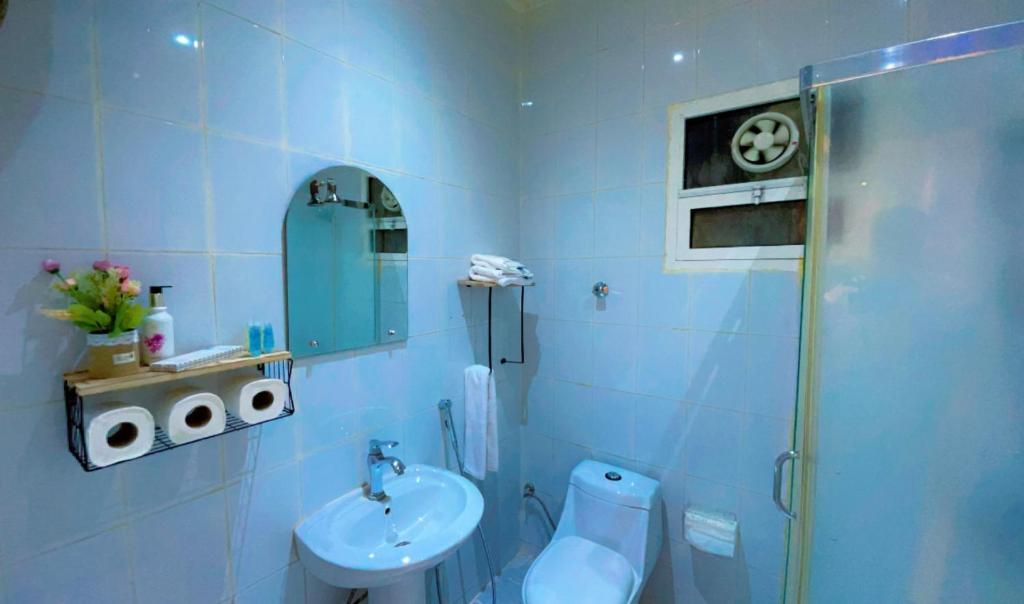 a blue bathroom with a toilet and a sink at شقة بالكامل حي المعذر 1 in Riyadh