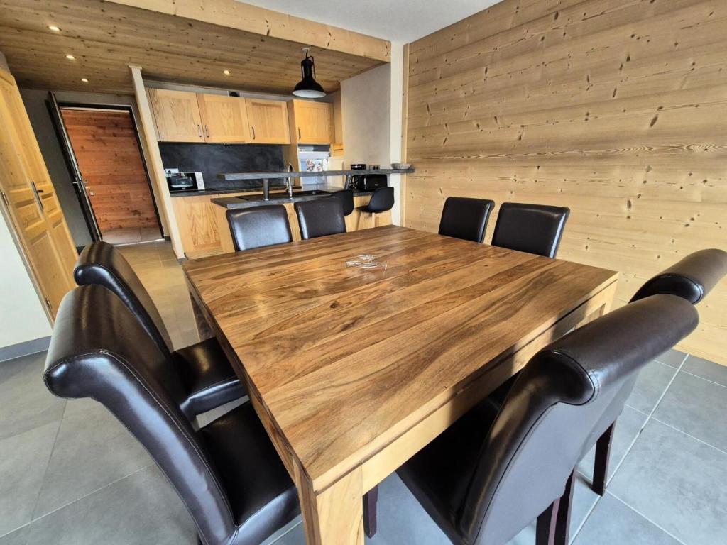 a wooden table and chairs in a room at La Residence - Appartement La résidence MAE-9451 in Vénosc