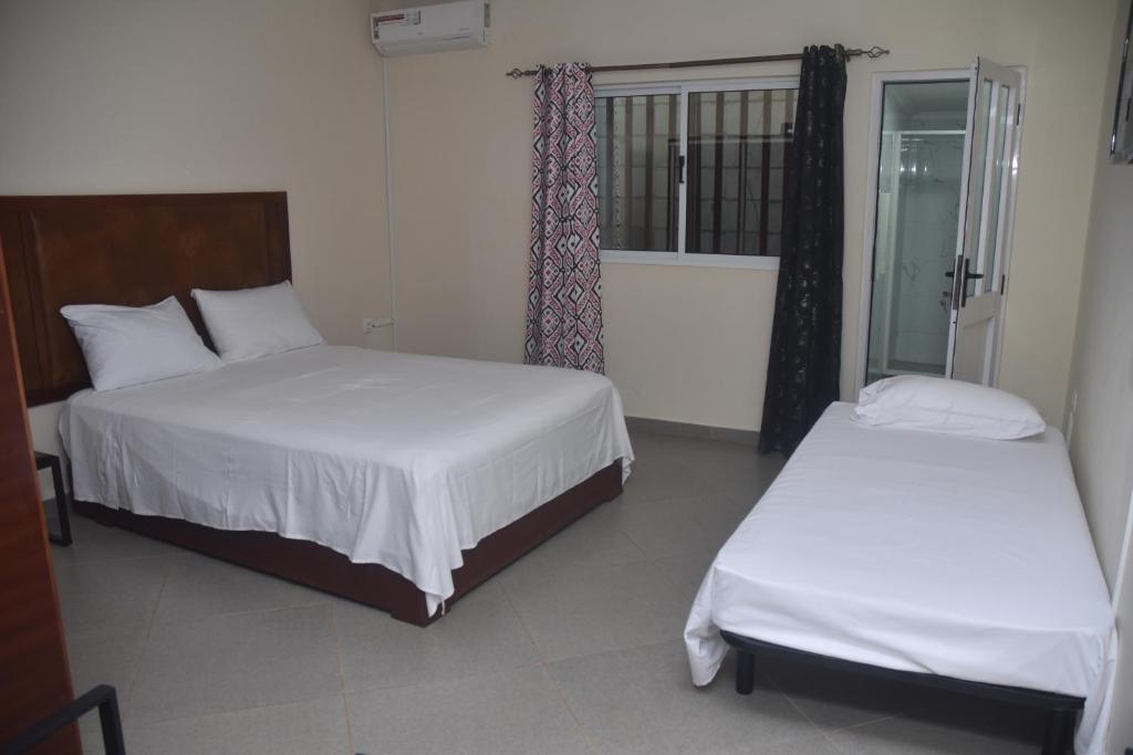 Postel nebo postele na pokoji v ubytování Hotel Cantinho