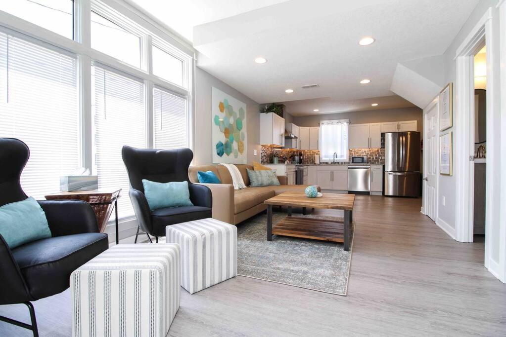 a living room with a couch and a table at Lux finishes 4 bedroom DSM home Great location in Des Moines