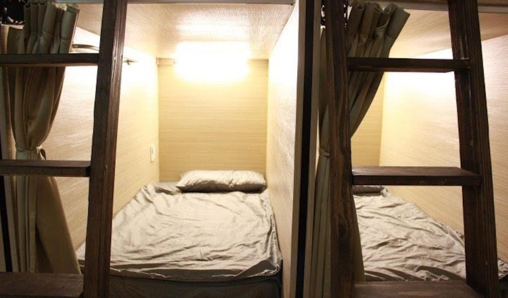 a small room with two bunk beds in it at FC Hostel-Ruifang Station in Ruifang
