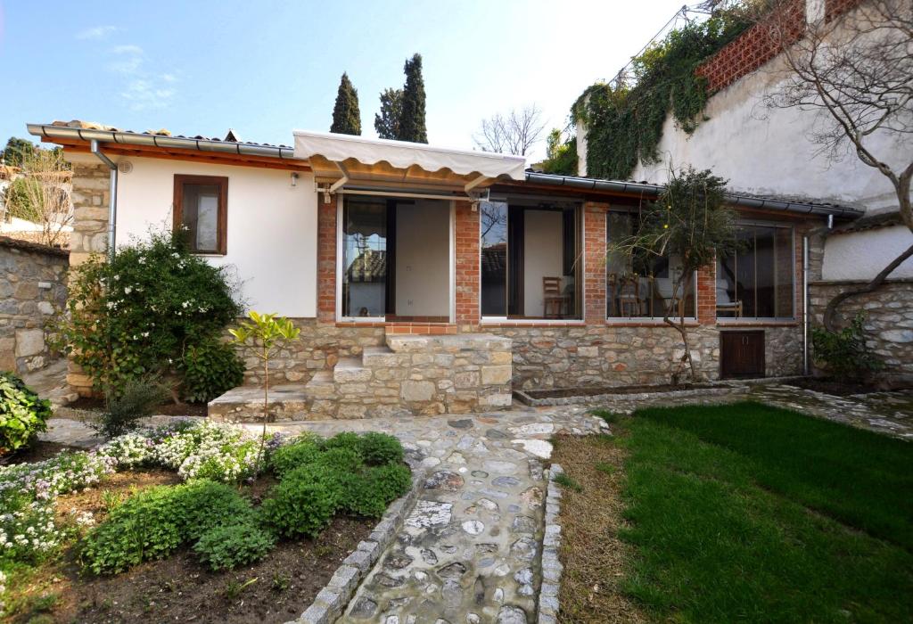 a stone house with a garden in front of it at Goldsmith House in Selçuk