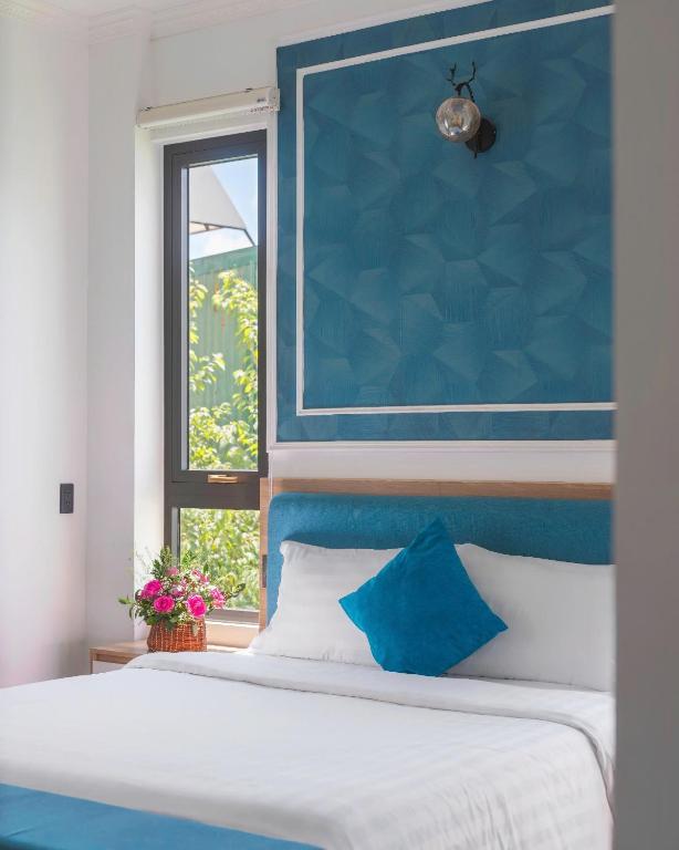Postel nebo postele na pokoji v ubytování VMT Hotel Da Lat