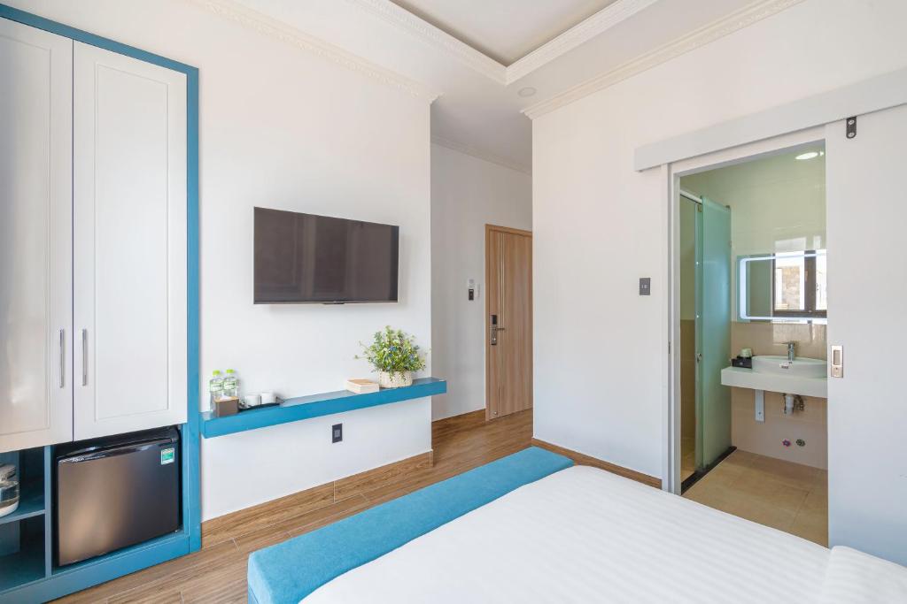 Postel nebo postele na pokoji v ubytování VMT Hotel Da Lat