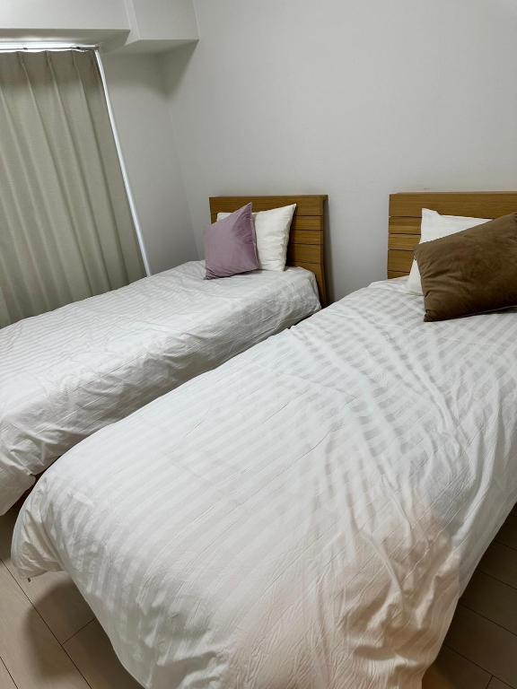 Postel nebo postele na pokoji v ubytování Residence天王寺東