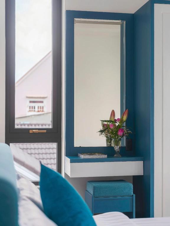 Postel nebo postele na pokoji v ubytování VMT Hotel Da Lat