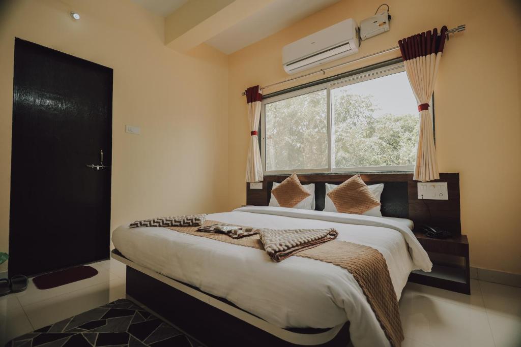 Postel nebo postele na pokoji v ubytování Hotel Mahabaleshwar Mount View