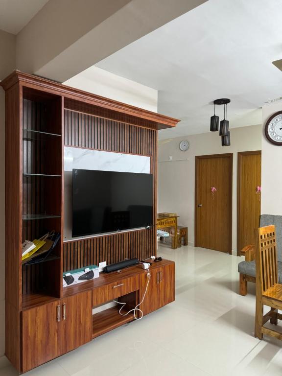 a large entertainment center with a television in a living room at Aami dhivahi guest house 01 in Trivandrum