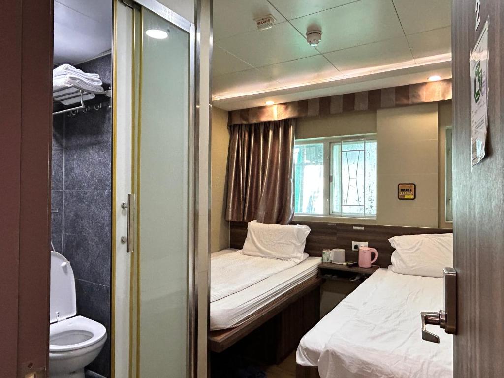 Postel nebo postele na pokoji v ubytování 香港星星旅馆 2202 Guesthouse