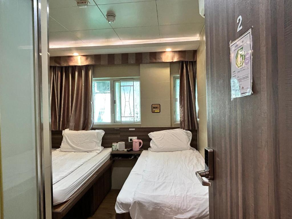 Postel nebo postele na pokoji v ubytování 香港星星旅馆 2202 Guesthouse