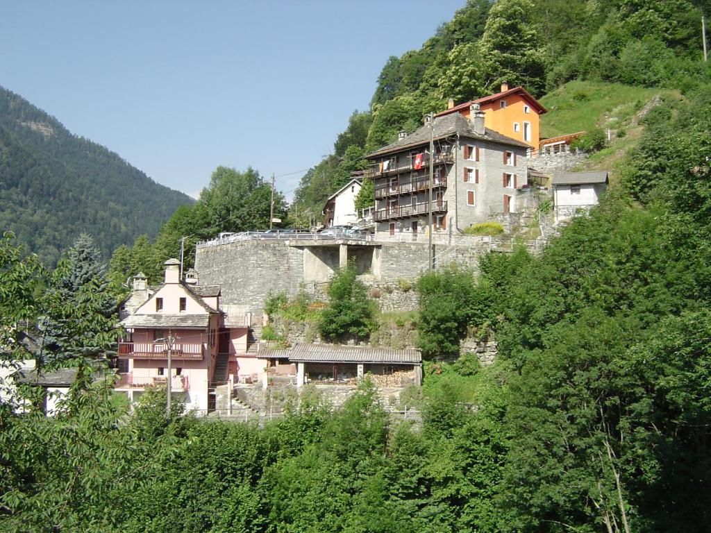 a group of buildings on a hill with trees at BnB "A la Crus" in Crana