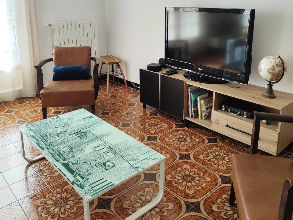 TV a/nebo společenská místnost v ubytování Les jardins Ducarouge 2 climatisé
