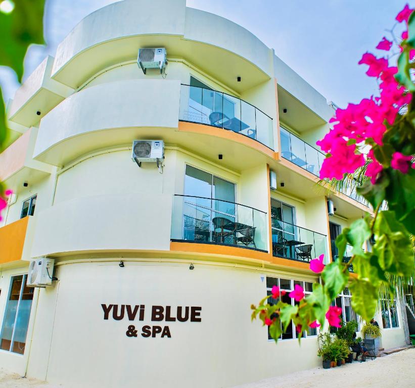 a building with a blue and spa sign on it at YUVi Blue Guesthouse at Himmafushi in Himmafushi