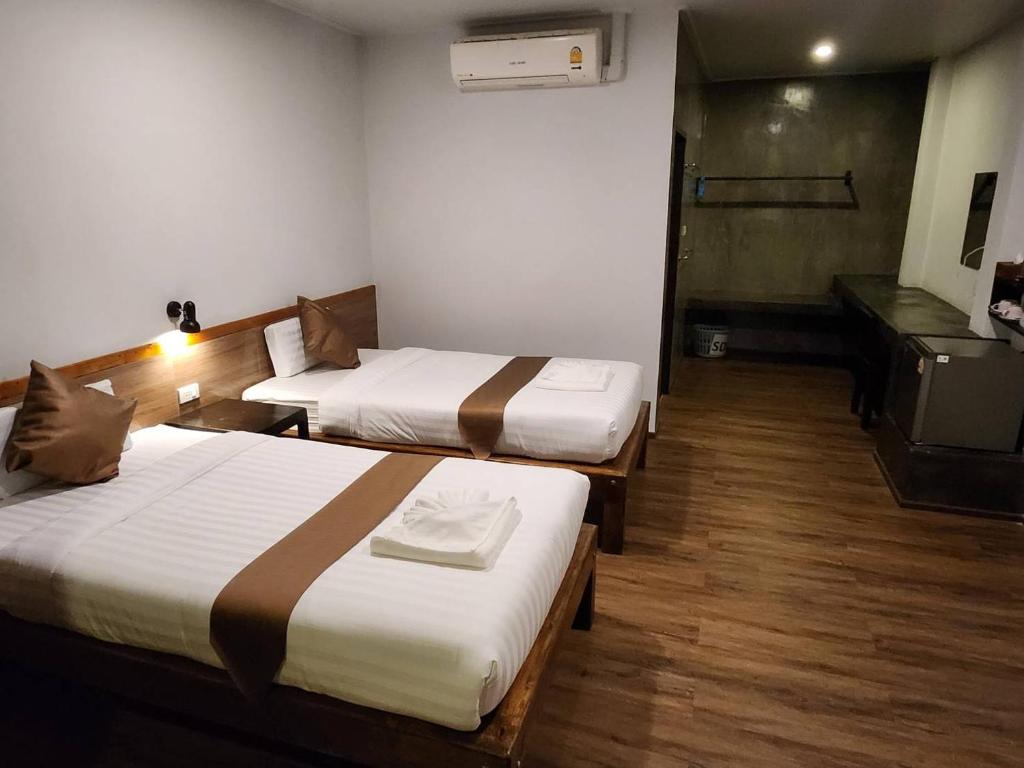 Postel nebo postele na pokoji v ubytování BuGaan Sukhothai Village
