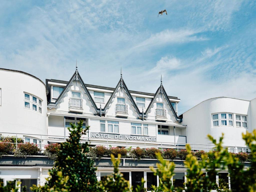 a large white building with a kite in the sky at Hotel De Normandie in Saint Helier Jersey