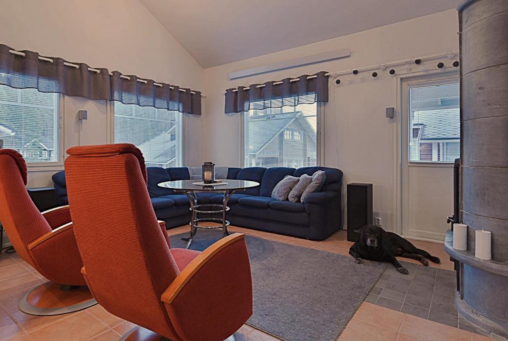 a living room with a couch and a dog laying on the floor at Central Alley 3B - including linen and towels in Levi