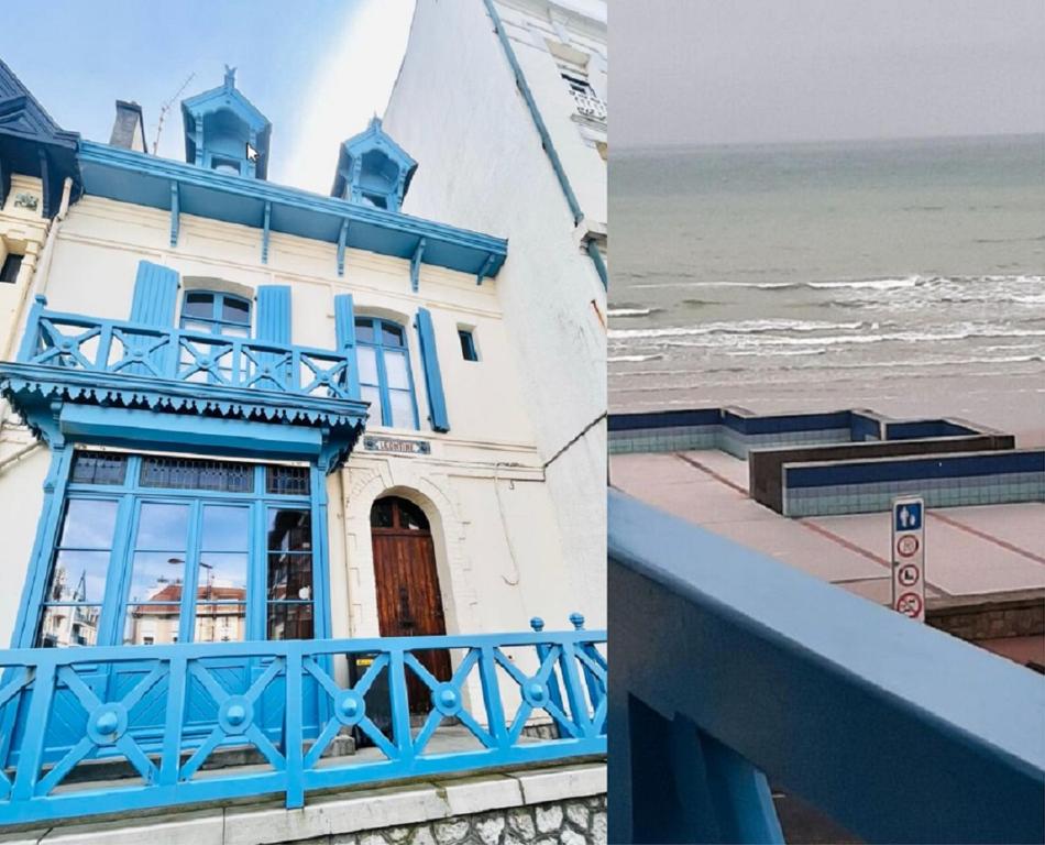 a building with blue trim next to the beach at Villa Léontine Wimereux in Wimereux