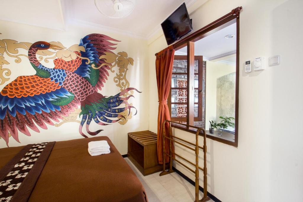 Postel nebo postele na pokoji v ubytování De Hostel Yogyakarta