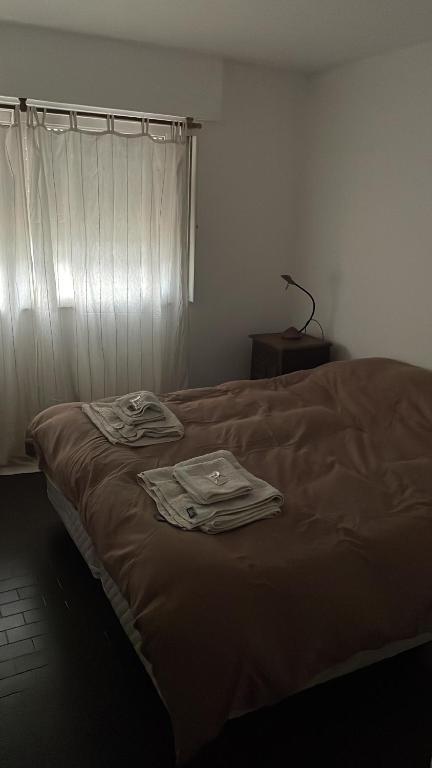 a bed with two shirts on it in a room at DEPTO MAC in Esquel