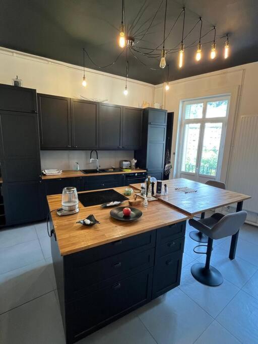 a kitchen with a wooden counter top in a room at Appartement entre lacs et montagnes in Saint-Claude