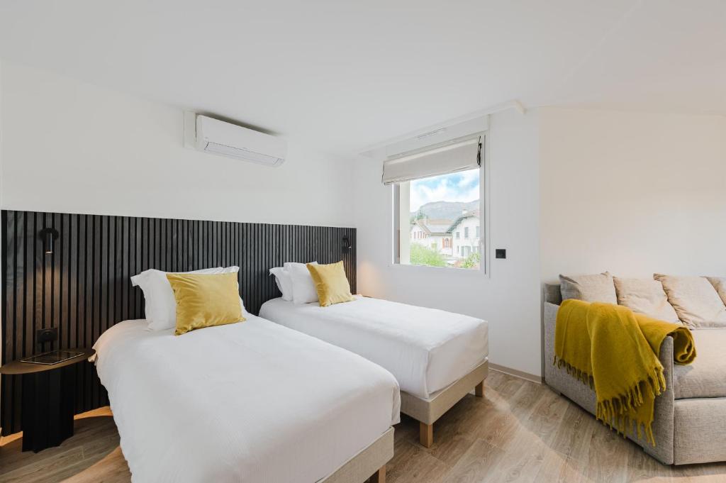 Postel nebo postele na pokoji v ubytování Appart Hotel Neostelia