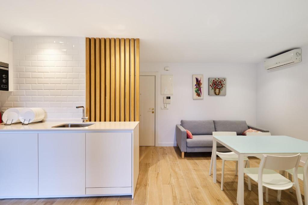 une cuisine et un salon avec une table et un canapé dans l'établissement Clínica Universitaria y Hospitales by Clabao, à Pampelune